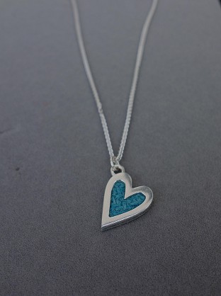 Sterling Silver with Harris Tweed. Approx 18x14mm with an 18inch chain