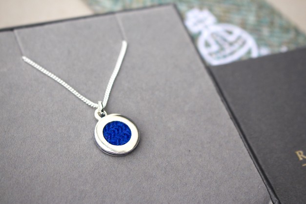 Sterling Silver and Harris Tweed.
Approx 15mm with an 18inch chain